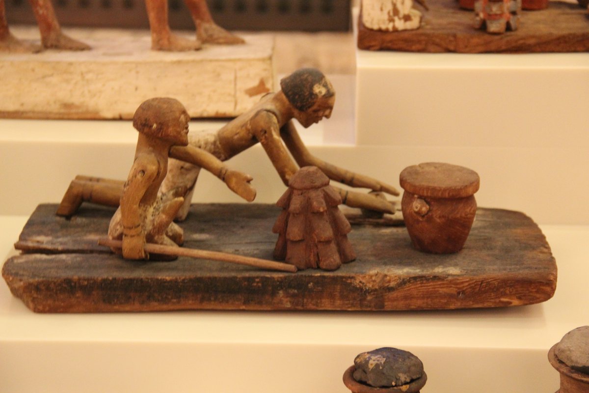 Ancient Egyptian wooden bakery model showing figures at work